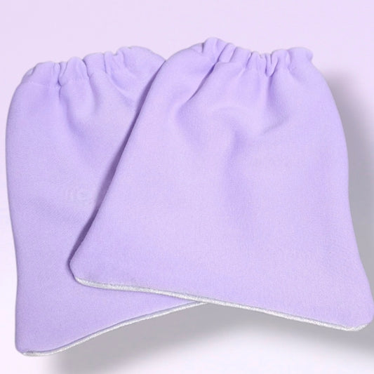 A pair of Lavender soft knit stirrup socks with elasticized cuffs, and light silver shimmer piping, shown overlapping on a light lavender background.